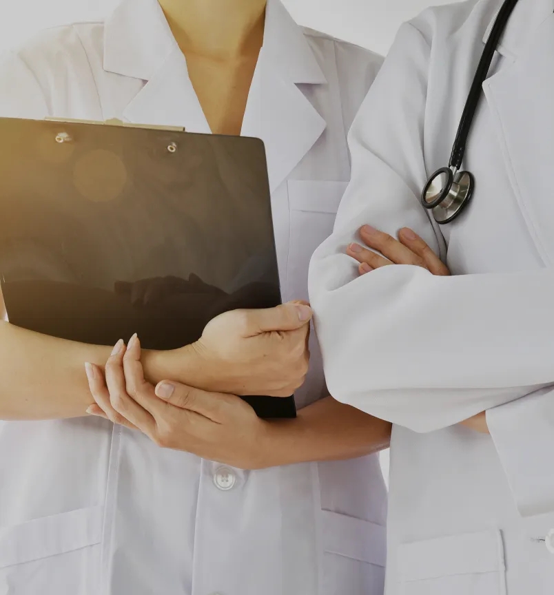 A diverse group of healthcare providers in a hospital setting, including doctors, nurses, and medical staff.